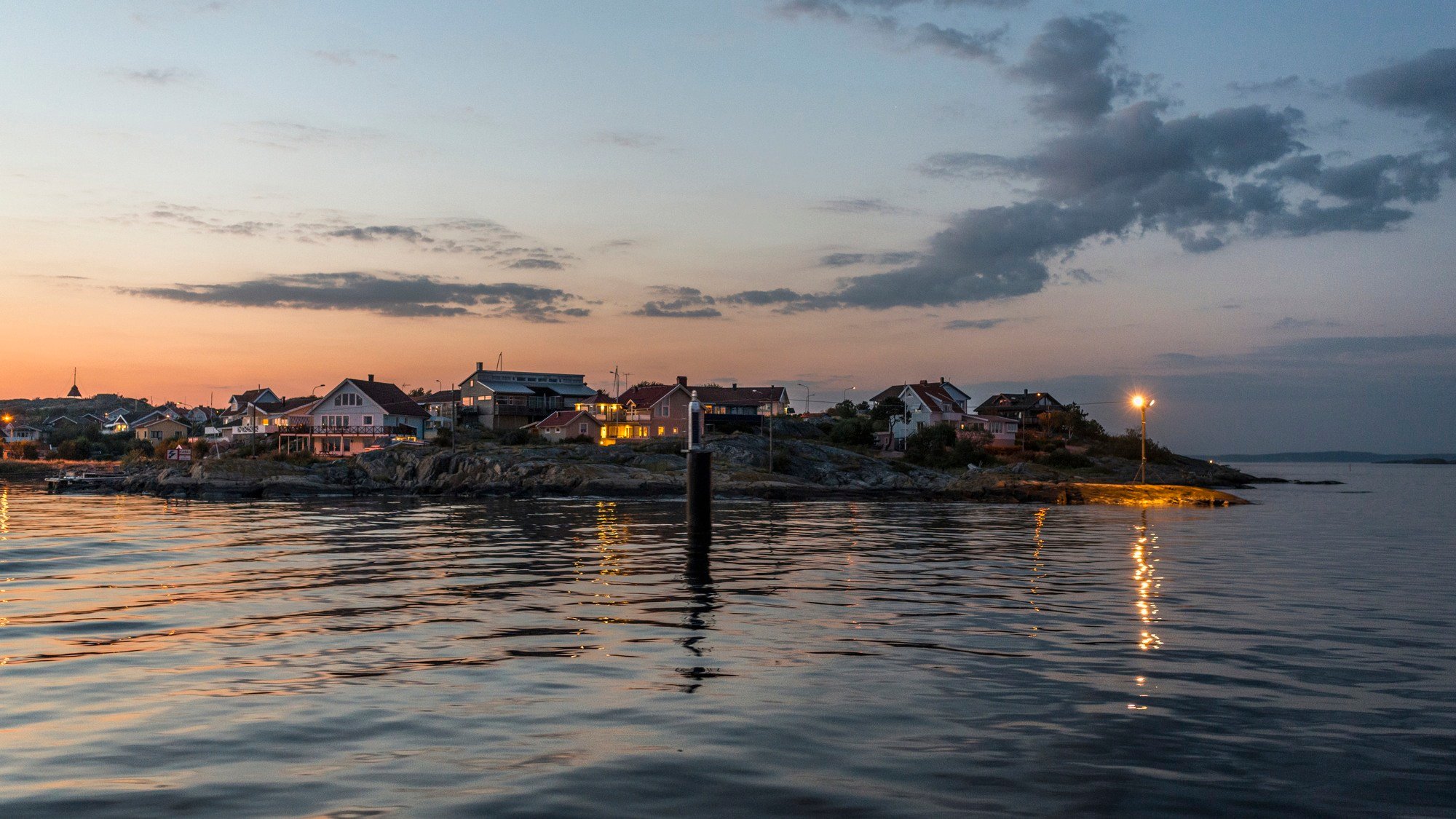 A body of water with houses in the background